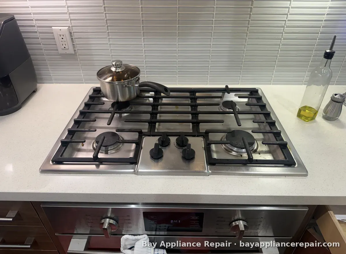 Five-burner gas cooktop installed above a wall oven