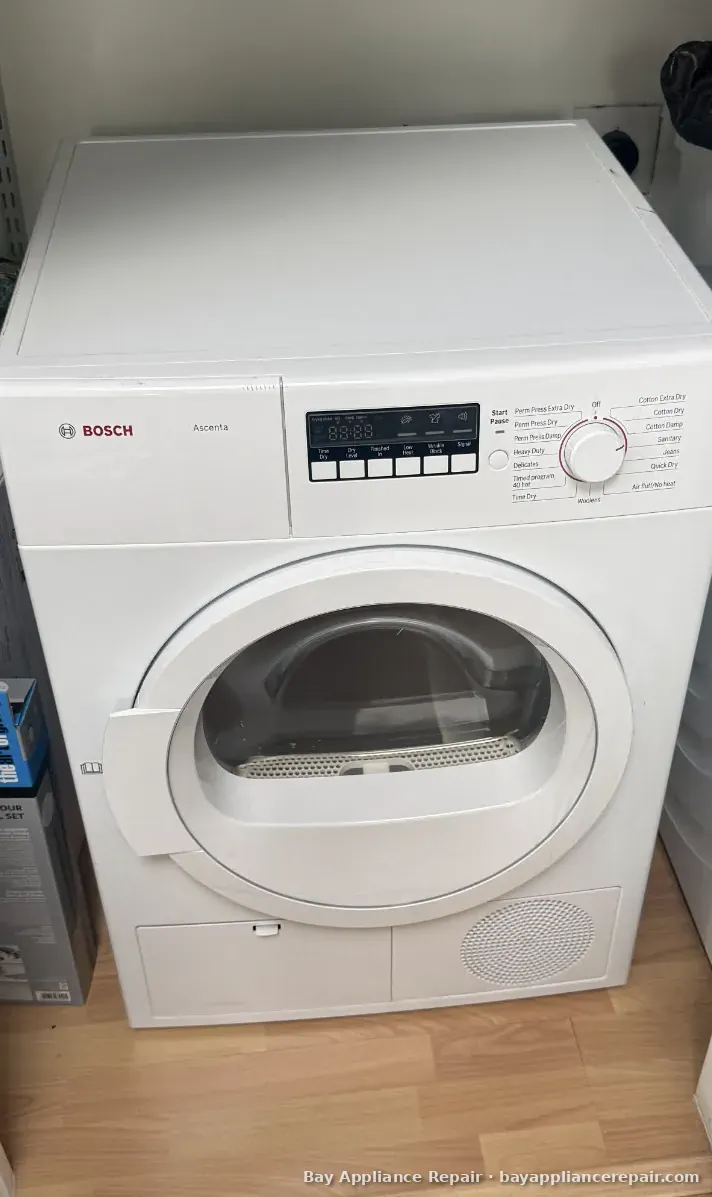 White Bosch front-load dryer in a laundry closet