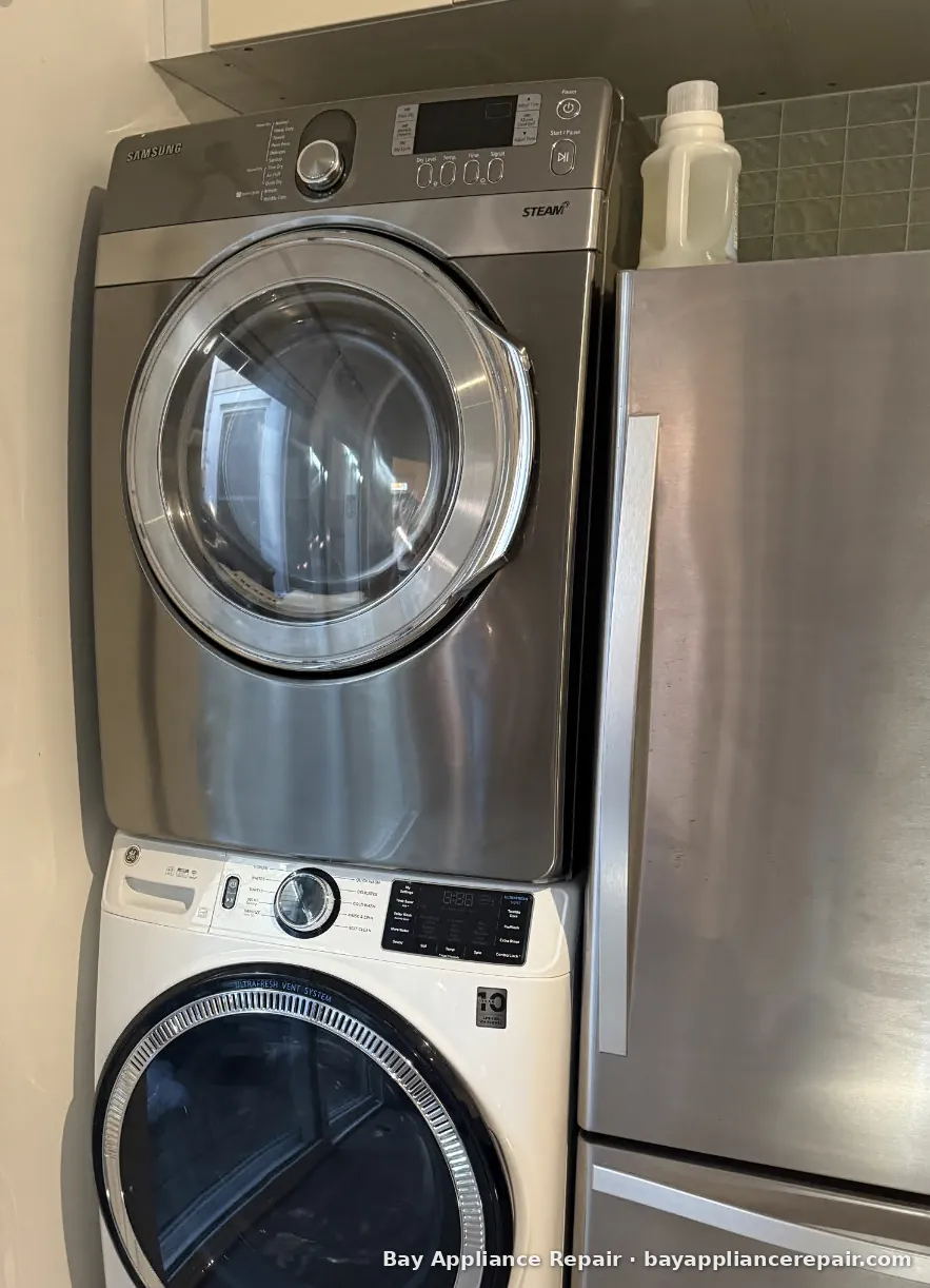 Samsung Steam front-load dryer stacked on a GE washer in a customer's laundry area
